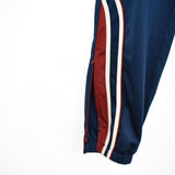 Vintage Lotto track pants tracksuit bottoms trousers in blue with red and white stripes.