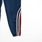 Vintage Lotto track pants tracksuit bottoms trousers in blue with red and white stripes.